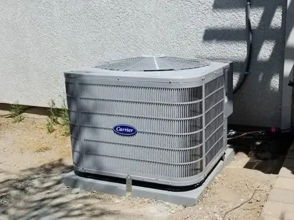 A large air conditioner sitting outside of a building.