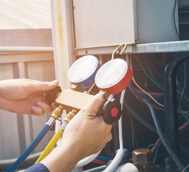 A person is working on an air conditioner.