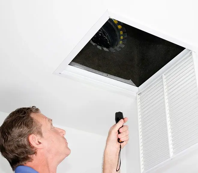 A man is looking up at the ceiling